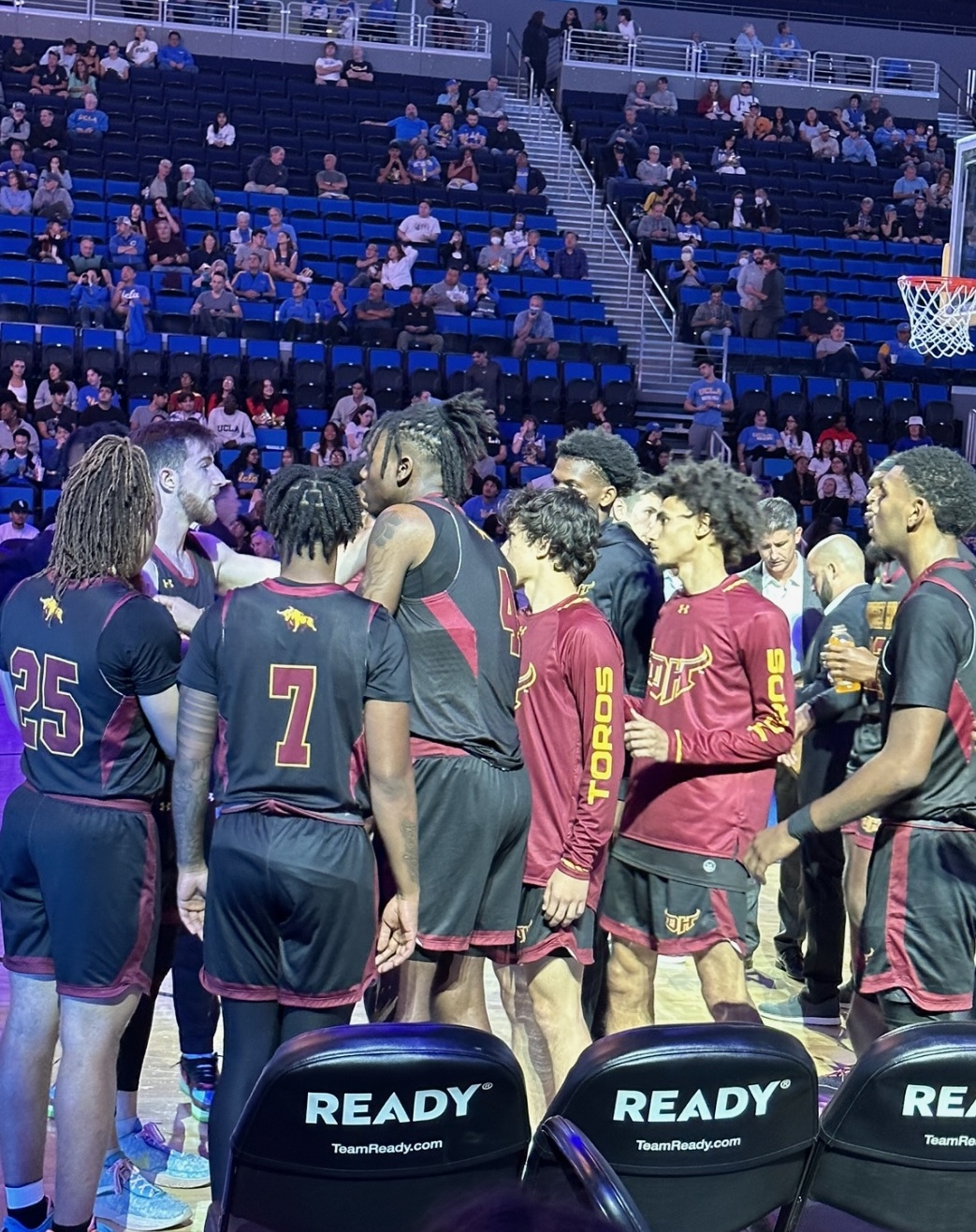 Photo of basketball players in a huddle.