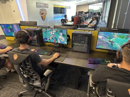Wider shot of people playing computer games.