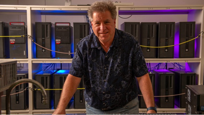 Portrait photo of man in short sleeved shirt in lab.