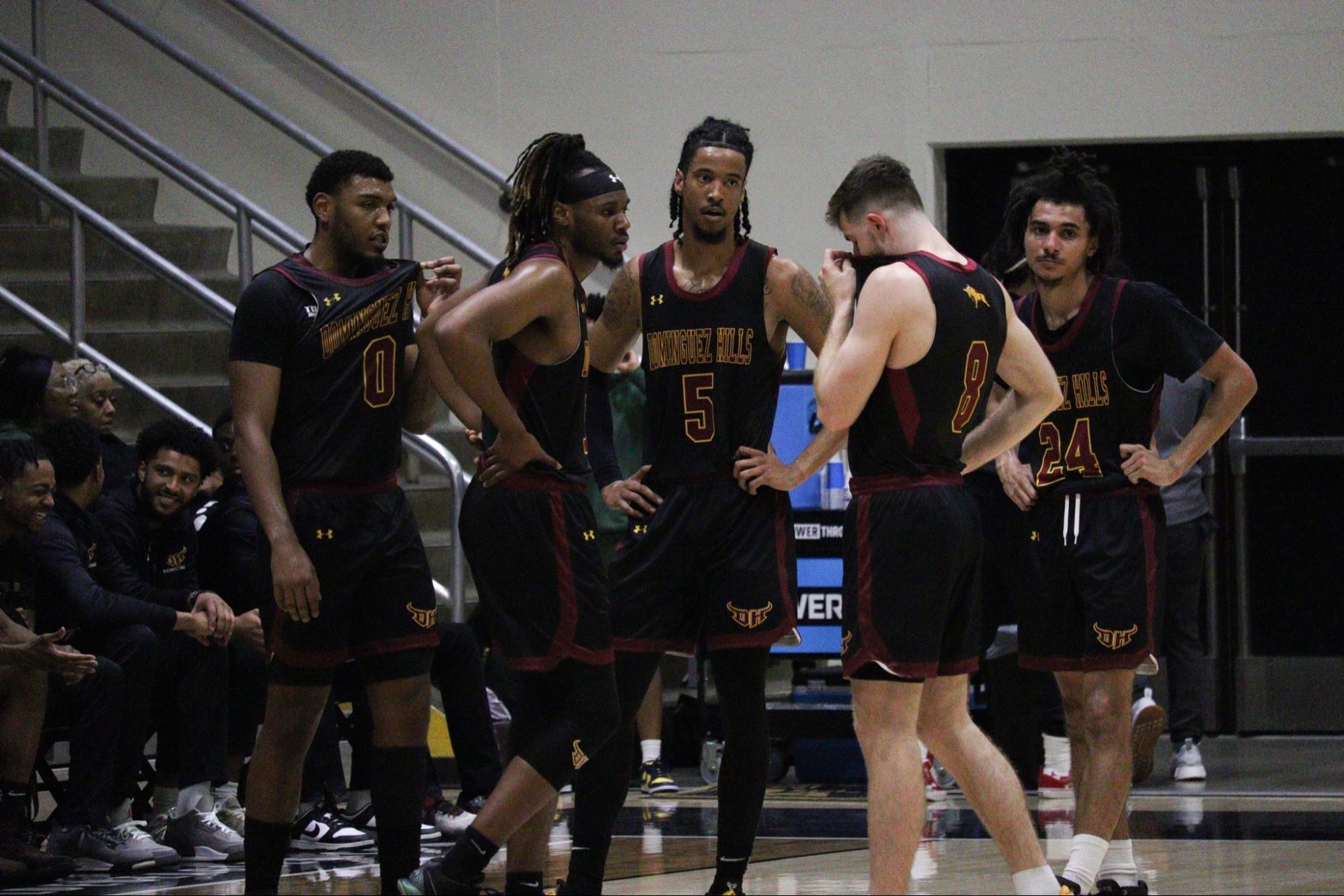 Photo of a group of five basketball players.