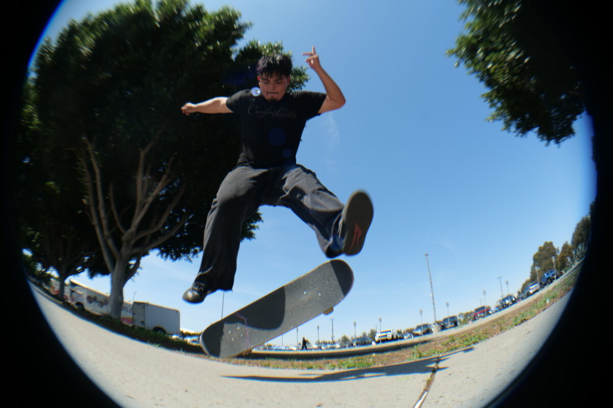 Student skater performs a kickflip in Parking Lot 17 during a Toro Skate Association meet-up.